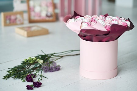 Delicious cakes or meringues or marshmallows in gift box close-up