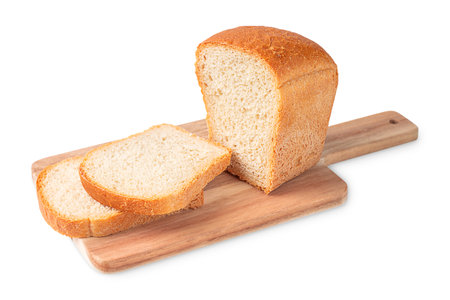 Homemade organic baked loaf of bread made of wheat flour and yeast sliced on wooden cutting board...