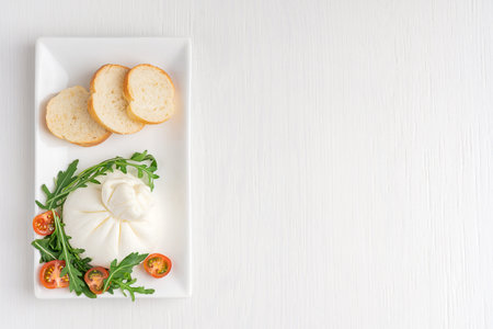 Top view of homemade organic burrata Italian milk cheese made of mozzarella and cream served in...