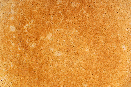 Background made of top view of buttery brown texture of homemade sweet thin French crepe dish made of unleavened batter cooked on a frying pan traditionally served as dessert snackの写真素材