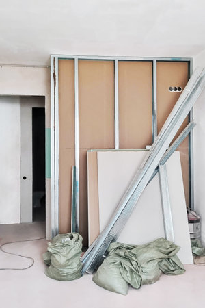 Interior construction site with drywall or plasterboard walls building representing renovation, improvement or reconstruction of new home, house or flat with rubbish bagsの写真素材