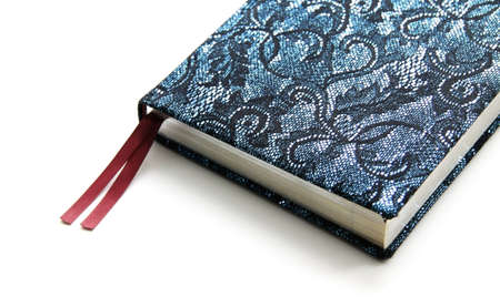 Notebook in a bright dark blue cover on white backgroundの写真素材