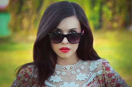 Portrait of beautiful young  brunette woman wearing sunglasses