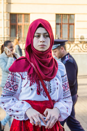Zaporizhia/Ukraine- May 19, 2016: Young Muslim woman wearing Ukrainian traditional blouse waiting for the beginning of celebration of traditional Ukrainian embroidered clothes, known as vyshyvanka  day, celebrated in all regions of Ukraine every third Thuのeditorial素材