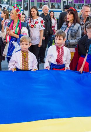 Zaporizhia/Ukraine- May 19, 2016: boys holding large Ukrainian flag on celebration of national Ukrainian embroidered clothes, known as Vyshyvanka  Dayのeditorial素材