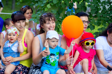 Zaporizhia/Ukraine- June 5, 2016: small children with mothers watching animation performance on charity family festival organized in regions with most quantity of refugees from Donetsk area, occasioned with International Children`s Dayのeditorial素材