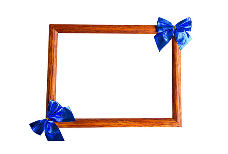 Wooden photo frame, decorated by blue ribbon bows, with blank space in center, isolated on whiteの写真素材