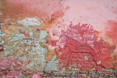 Old and weathered grunge brick wall with peeled and cracked paint layers, abstract textureの写真素材