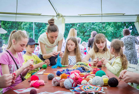 Zaporizhia / Ukraine- May 28, 2017: Charity Family festival- young woman - volunteer explaining to...