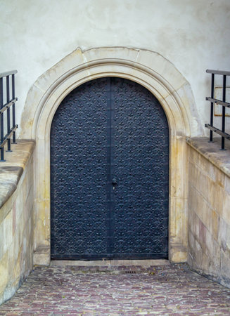 Krakow / Poland - August 14, 2017: Wawel Royal Castle, ancient iron ornate door at stone wall of palaceのeditorial素材