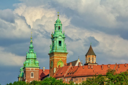 Krakow / Poland - August 14, 2017: view of Wawel Cathedral Towers and museum building over a cloudy dramatic sky on a summer dayのeditorial素材