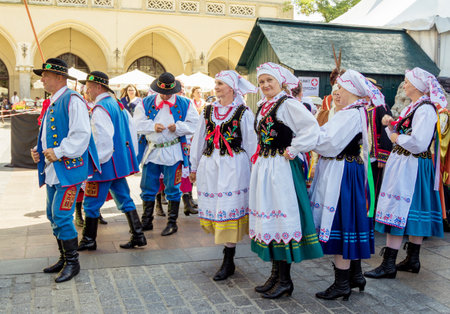 Krakow / Poland - August 15, 2017: dancing group - men and women, wearing traditional clothes, waiting for the beginning of performance, on celebration of the Polish Armed Forces Day at main Market Squareのeditorial素材