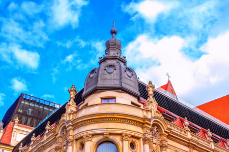 Wroclaw / Poland - August 17, 2017: part view of Monopol Hotel historical building - ornate roof tower with small round windows, balconies and glass hedge of open air restaurant. Neo-baroque architecture details.のeditorial素材