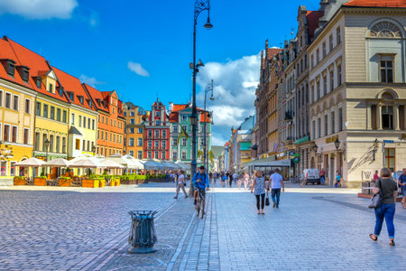 Wroclaw / Poland - August 17, 2017: cityscape of old town Market Square with colorful historical buildings, citizens ant tourists walking aroundのeditorial素材