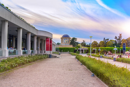 Wroclaw / Poland- August 17, 2017: view of park near the Centennial Hall with an ivy colontade walkway, observing dome and restaurant, summer evening, sunset skyのeditorial素材