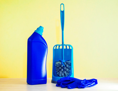 Toilet brush, disinfection detergent in blue plastic container and protective rubber gloves. Home cleaning concept.の写真素材