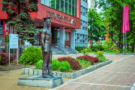 Katowice / Poland- May 2, 2018: view of the University of Silesia with a student sculpture, green trees and flowerbedsのeditorial素材