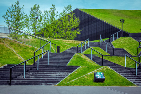 Katowice / Poland- May 2, 2018: view of green grass lawns and symmetric black stairs near International Congress Hall building in city center with modern designのeditorial素材