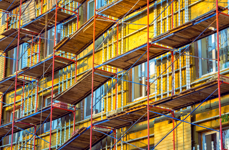 Building facade renovation - high scaffolding at construction site. Urban architecture.の写真素材