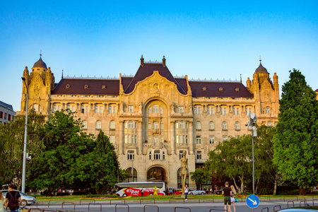 Budapest/Hungary- May 6, 2018: View of beautiful Four Seasons Hotel Gresham Palace Budapest building - Art Nouveau architecture example. Green trees and blue sky.のeditorial素材
