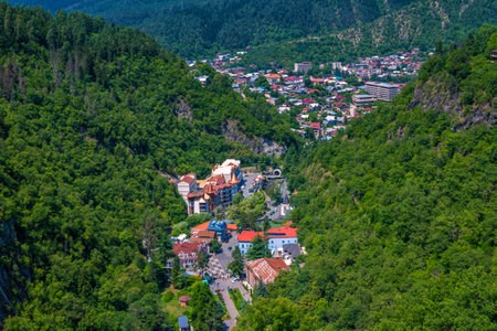 Borjomi/Georgia â July 17, 2019: View of famous Georgian resort â mountain village â Borjomi. Summer landscape with mountains, covered with green trees, colorful houses of small town and blue sky.のeditorial素材
