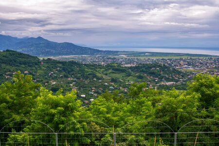 Aerial view - summer landscape of Georgian Black Sea resort -mountains, green trees and clouds on...