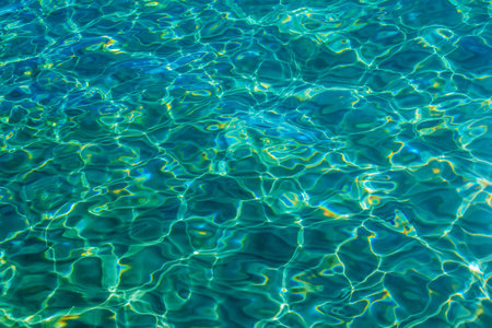 Close up crystal clear, turquoise color sea water with sunlight reflections on surface. Summer natural background.の写真素材