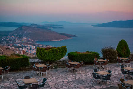 Street cafÃ© with stunning view â€“ seascape, hills, mountains and islands. Albanian resort...