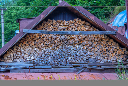 A pile of fire wood chopped and prepared for burning and heating the house in rural area in winter.