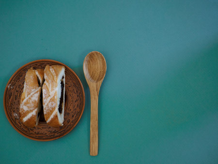 Antique handmade plate made of clay and birch bark with pieces of cake with bird cherry on a...