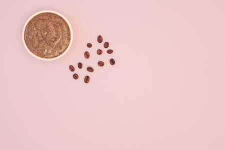 Natural coffee body scrub for cellulite. Coffee beans on a pink background. Body skin care. Flat lay, top view, copy spaceの写真素材