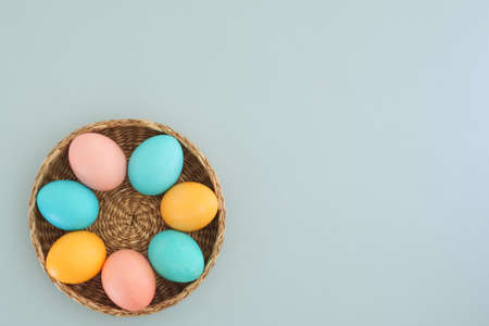 Minimalistic Easter background with pastel Easter eggs on a light blue background with place for text. Flat lay, top view. Easter spring holiday conceptの写真素材