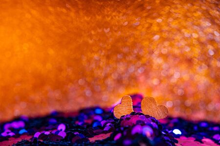 Hearts on Bright fabric with brilliant paillettes. Rose gold hearts glitter, Abstract holidays background. Texture, light bokeh background, Glitter lights background.の写真素材