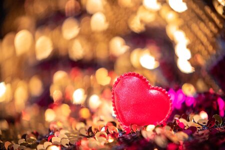 Shiny heart on Bright fabric with brilliant paillettes. Rose gold hearts glitter, Abstract holidays background. Texture, light bokeh background, Glitter lights background.の写真素材