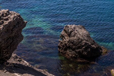 Amazing view on black sea near rocks in hot summer. Vacation, summer travel. Rocks in the Black Sea. Stone in the Black Sea. Crimeaの写真素材