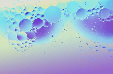 Abstract background. Orange with purple color. Distortions in water with drops of oil. Bright abstraction, ultraviolet. Circles on the waterの写真素材