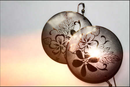  round metallic  earring with flowers, pair on hooks,  plaquesの写真素材