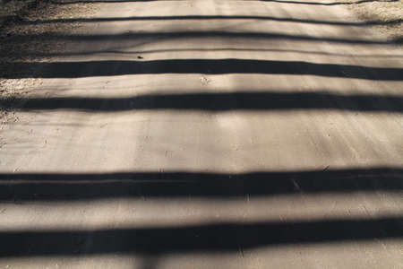 narrow stripes of shadow on solid brown groundの写真素材