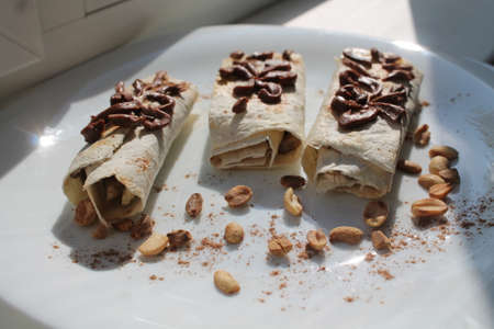 light vegetarian sweet snack banana cake with chocolate flowers onの写真素材