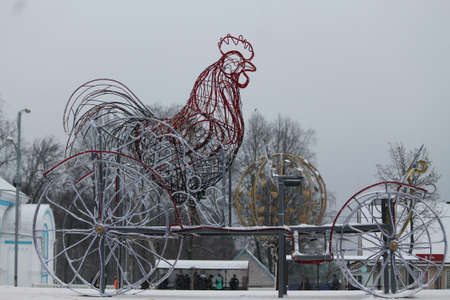 symbol of New Year red brave rooster from lights stay on carriage decoration for winter holidaysの写真素材