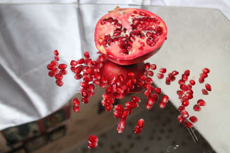 beautiful bright red color juicy and sweet pomegranate with crystal grains of seedsの写真素材