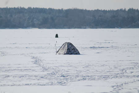 fishmen camp on the frozen sea in cold winter sunny dayの写真素材