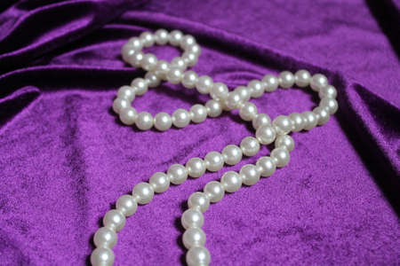 thread of pearl bead on velvet