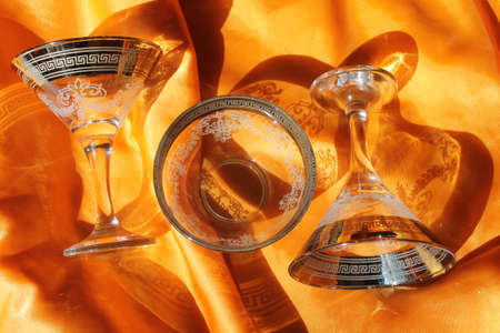 crystal wineglass on golden silkの写真素材