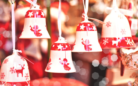 Porcelain bells with painted angels at the Christmas market. A gift for a Christmas holiday.