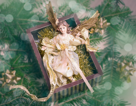 A toy angel in a gift box. A gift for a Christmas holiday.の写真素材