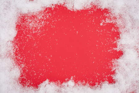 White Snow Around Central Copy Space On Red Paper Background.の写真素材
