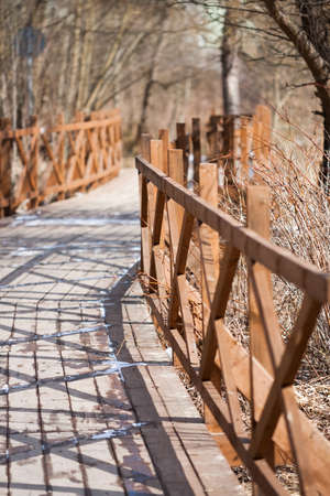Wooden Bridge On Coast River In Spring Moscow Park.の写真素材