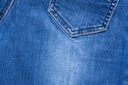 Background And Texture Of Blue Jeans Fabric With Yellow And Blue Seams Close Up And Top View.の写真素材