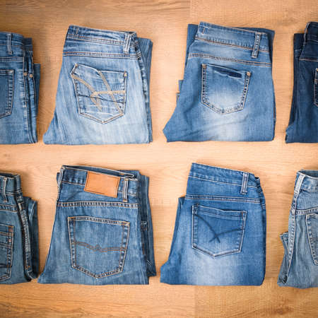 Jeans. Blue Denim On Brown Table Background Top View.の写真素材